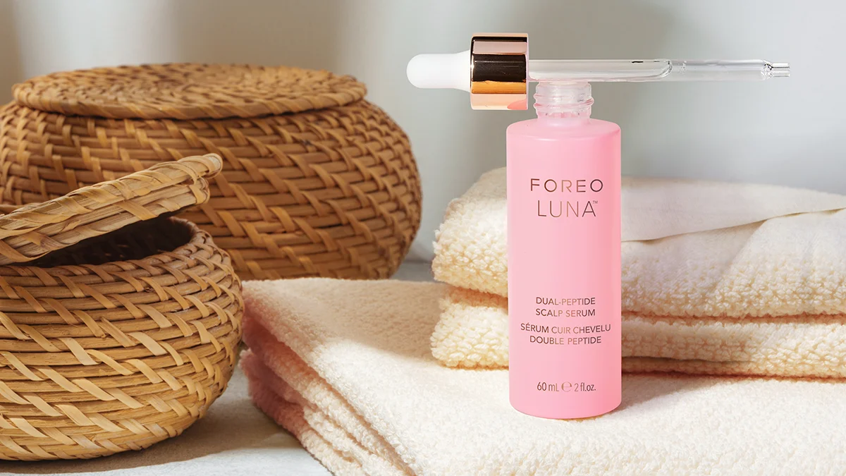 Luna Dual-Peptide Scalp Serum next to woven baskets in a gorgeous bathroom